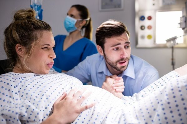 Gruppo Donnamed Uomo che conforta la donna incinta durante il parto